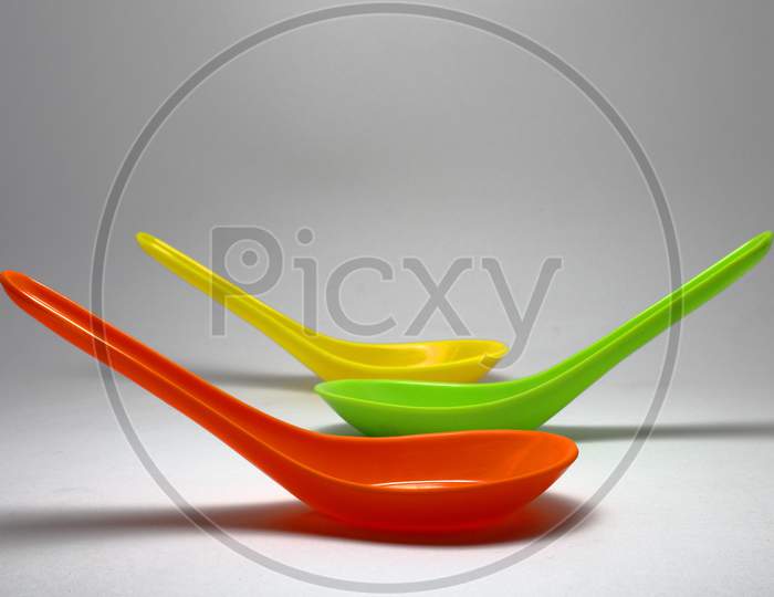 Colorful Spoons Isolated On A White Background