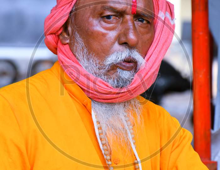 Indian Monk wear orange cloths and looking front