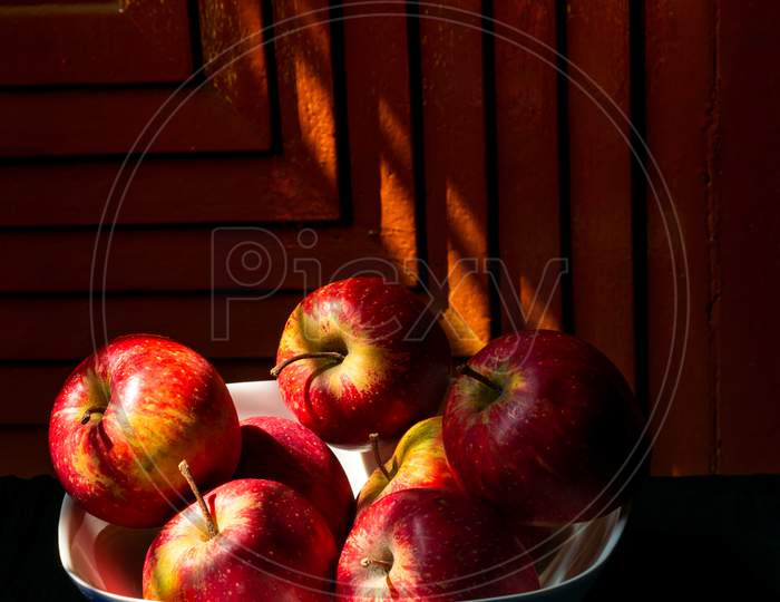 A Bunch Of Healthy Apples Stacked Together In A Bowl
