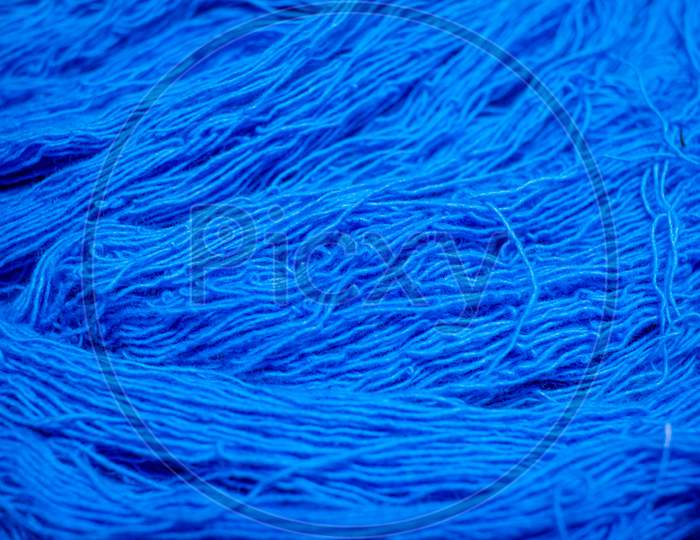 Close View Of The Blue Color Thread Yarns Used In Textile Industry