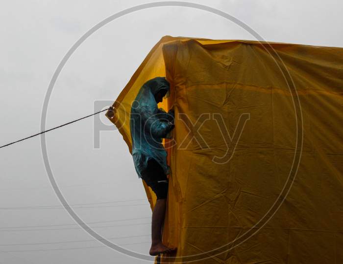 Farmers fix their tents during the rain at Gazipur border on January 4, 2021 in New Delhi, India. Thousands of farmers, mainly from Punjab, Haryana and western Uttar Pradesh, are protesting at various Delhi borders for over a month against the three laws.