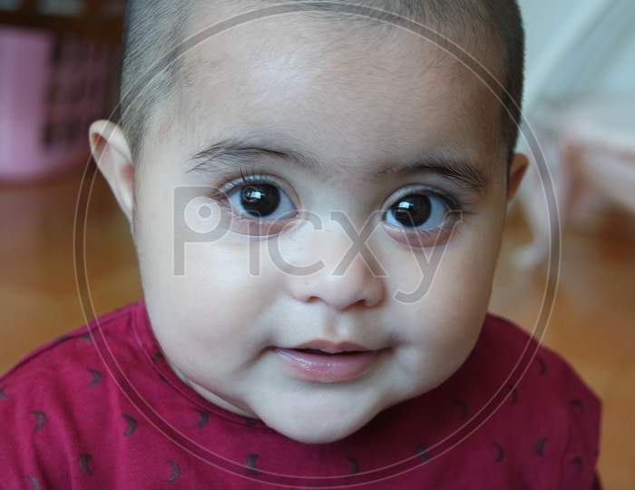 Baby Girl With Lovely Face, Big Eyes And Cute Face Gesture.