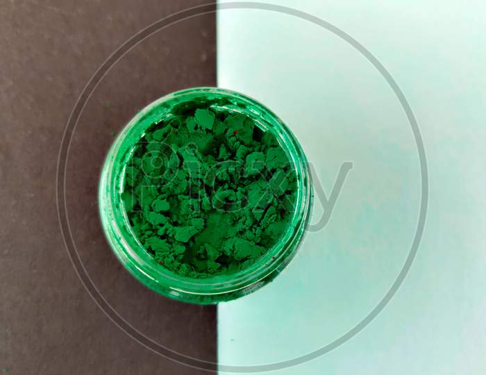 Forehead Green Color Powder In Plastic Box. Isolated On Black And Green Background. South Indian Tradition.