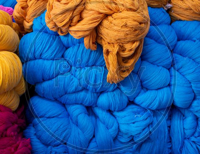 View Of The Blue And Orange Color Thread Yarns Used In Textile Industry