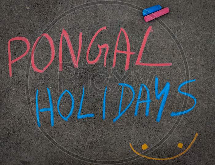 The Inscription Text On The Grey Board, Pongal Holidays. Using Color Chalk Pieces.