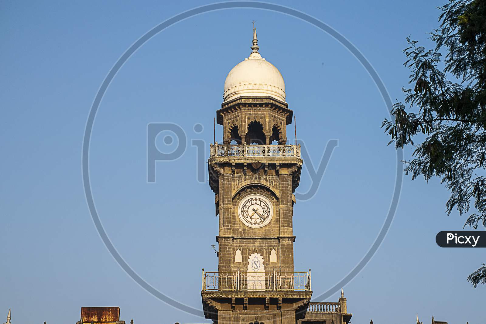 Front View Of Royal Old Exterior Clock Tower At Shalini Palace Hotel, Kolhapur City India.