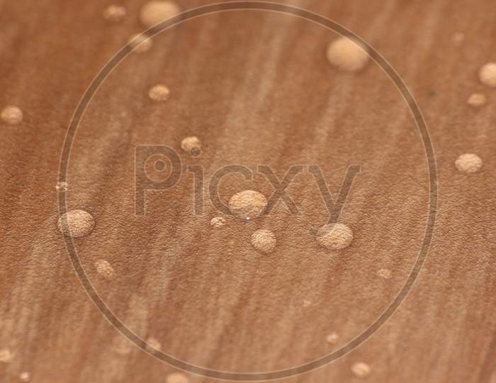 Closeup Selective Focus View Of Water Drops On Wooden Floor.