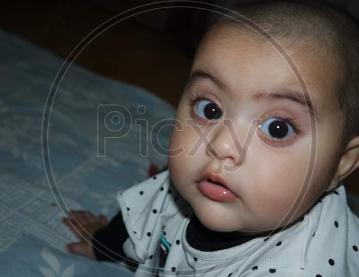 Baby Girl With Lovely Face, Big Eyes And Cute Face Gesture