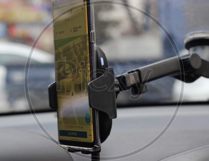 Smart Phone Holder Attached To Windscreen Of Car