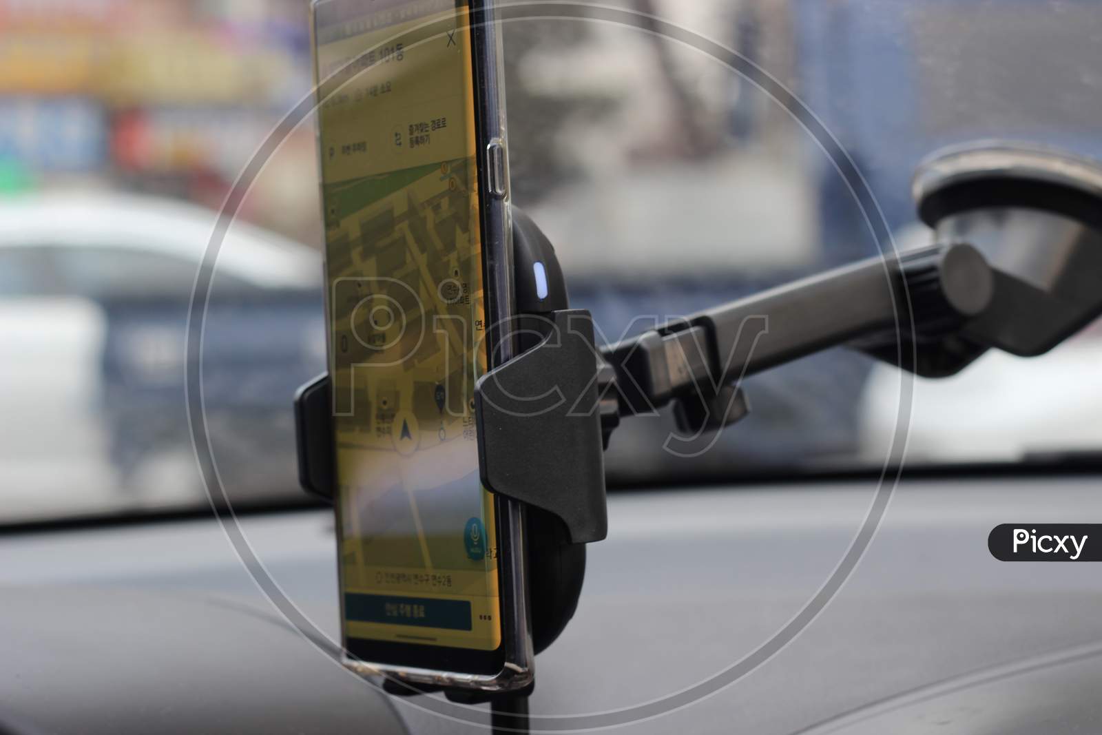 Smart Phone Holder Attached To Windscreen Of Car