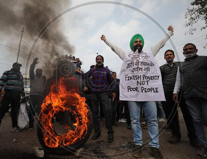 Bus drivers burn tyre during their day-long strike from Lakhanpur to Kashmir, organized by All J&K Transport Welfare Association, in support of their demands like waiving off token tax, passenger tax and renewal fee penalties due to COVID-19, at a bus stand in Jammu,6 Jan,2021.