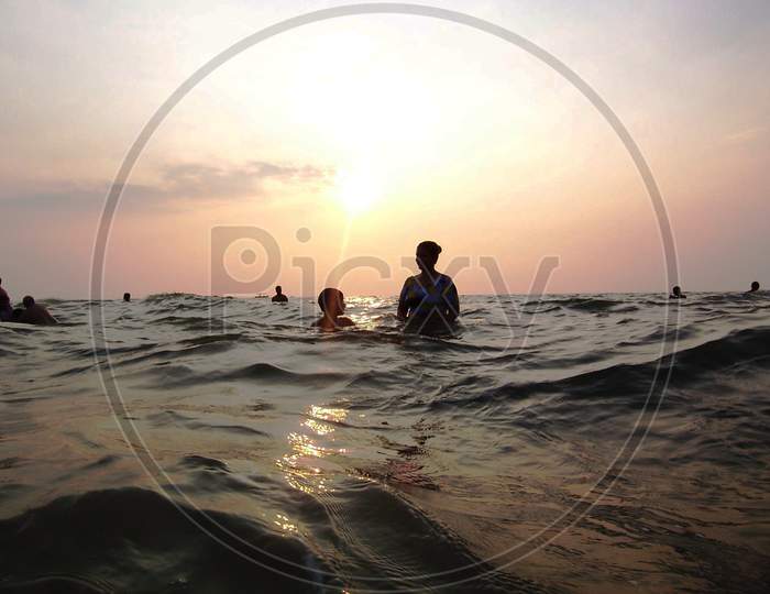Gentle sea waves and Sunset in the backdrop at Colva Beach, Goa