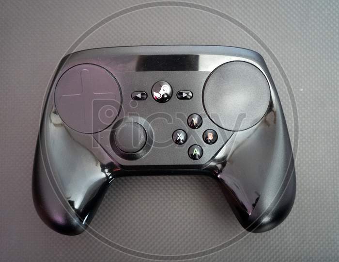 The Steam Controller On A Carbon Fiber Background Showing Technology Of Inputs For Computer Gaming