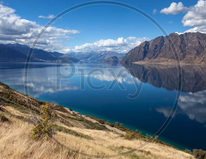 Scenic View Of Lake Hawea And Distant Mountains