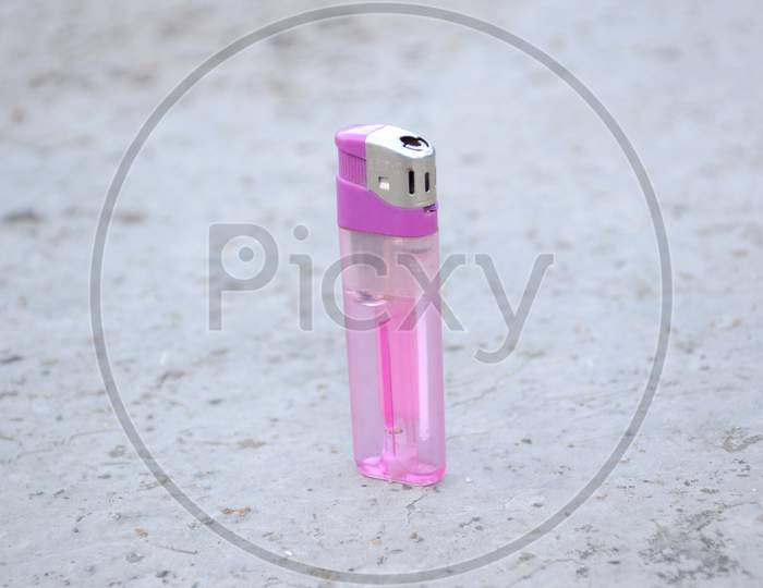 The Purple Color Gas Lighter Isolated On Grey Background.