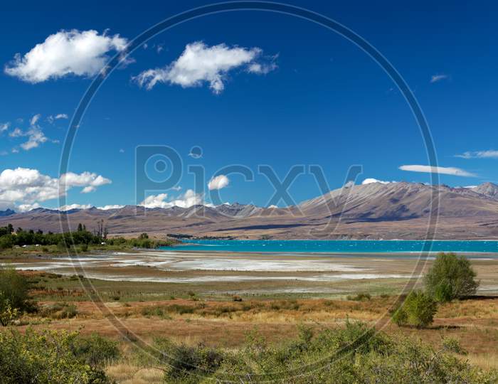 Distant View Of Lake Tekapo On A Summer'S Day