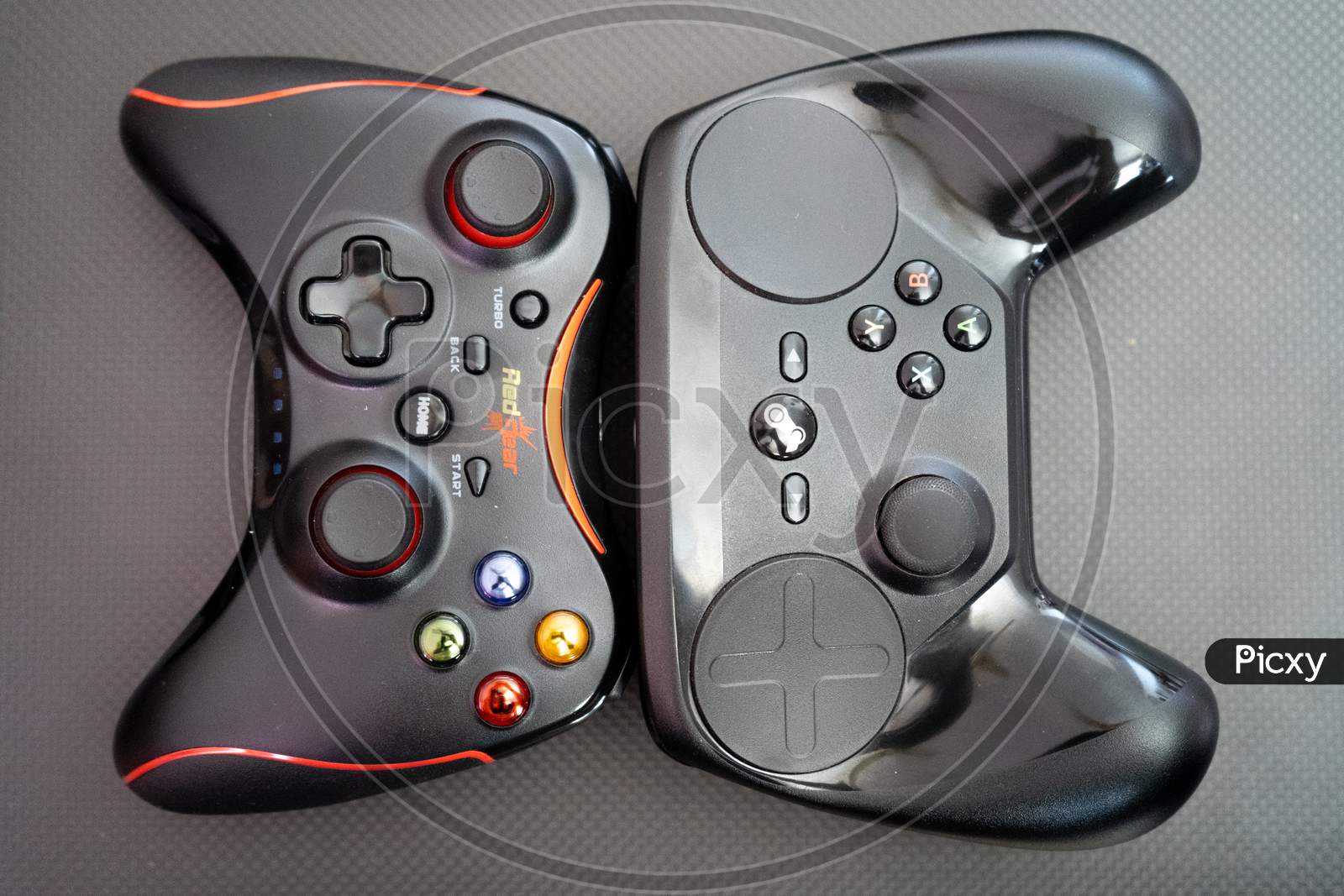 Redgear Vs The Steam Controller On A Carbon Fiber Background Showing Technology Of Inputs For Computer Gaming