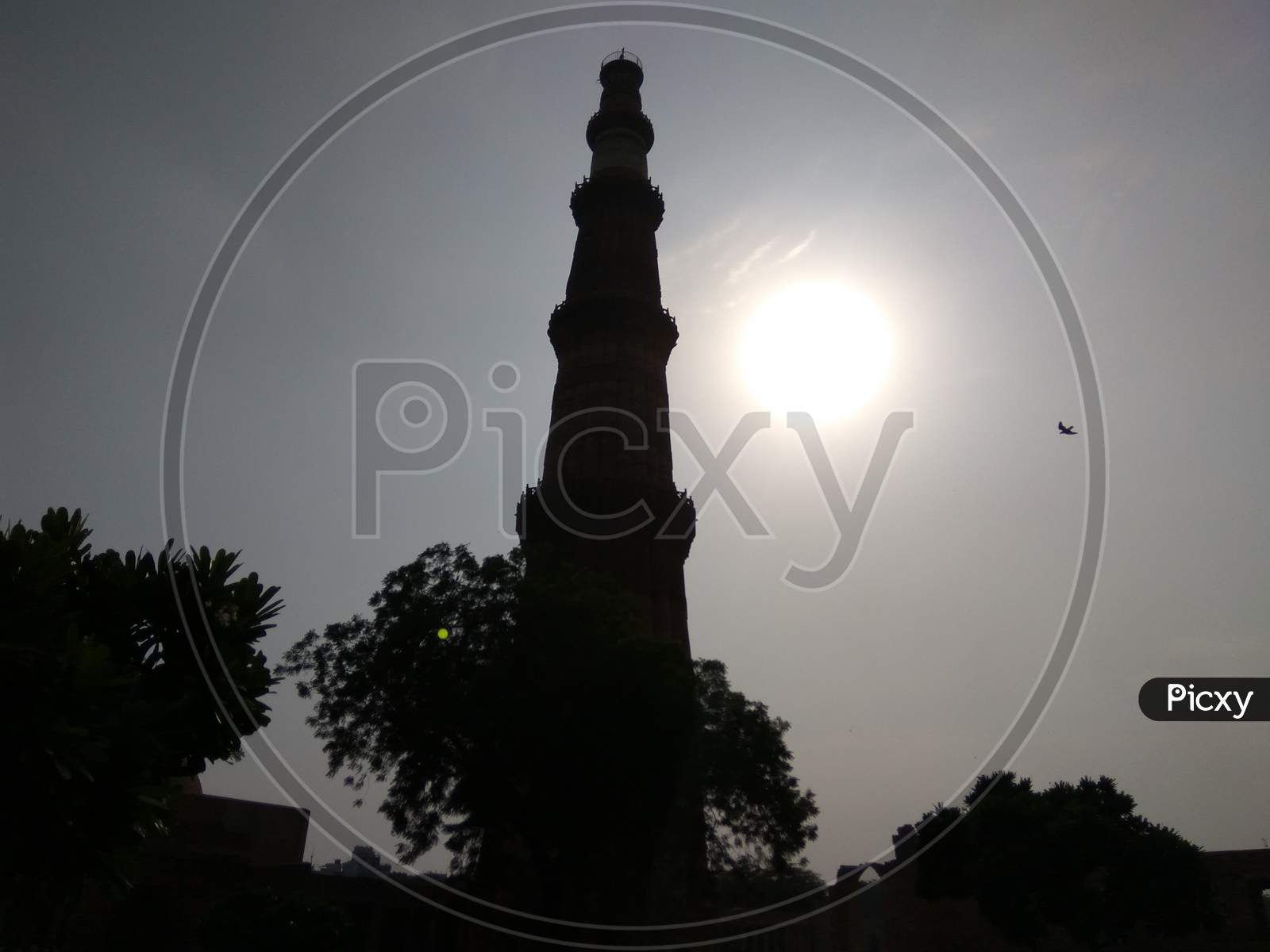 Sun in the backdrop of Qutub Minar, Mehrauli, Delhi