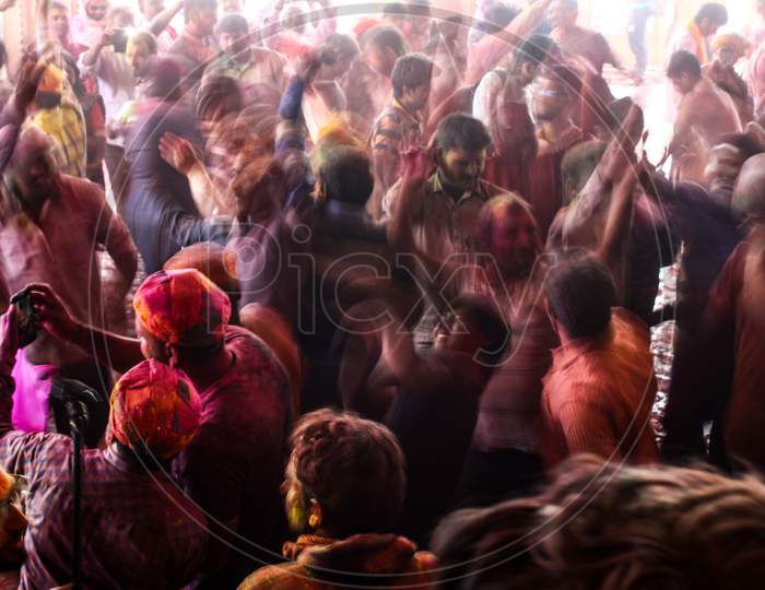 Mathura, Uttar Pradesh/ India- January 6 2020: A Crowd Of People Raising Their Hands Up And Enjoying Music On The Street Of Mathura Celebrating Holi Festival With Color Powder Captured In Slow Shutter Speed.