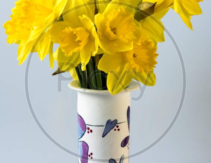 A Bunch Of Of Golden Daffodils In A Decorated Ceramic Vase