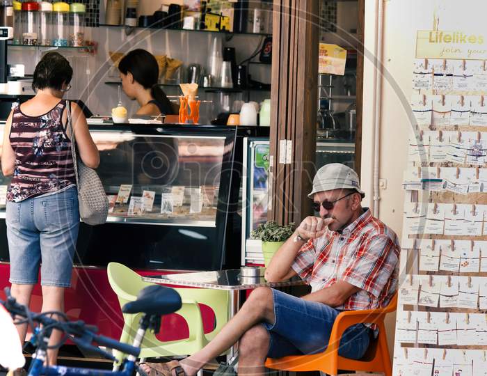 Crete, Greece - September 16, 2017: Exterior Of An Ice Cream Shop And Customer Sitting Outside In The City Center Location Of Agios Nikolaos In Europe.