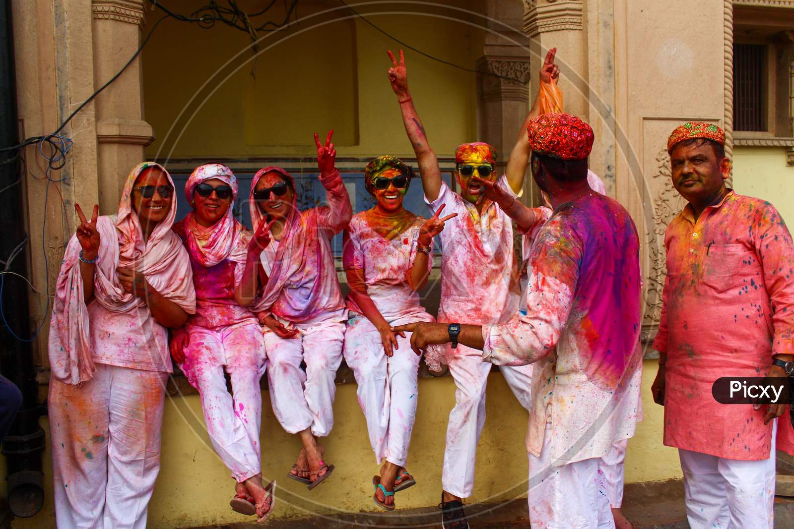 Mathura, Uttar Pradesh/ India- January 6 2020: A Group Of Friends , Faces Smeared With Colors , Having Fun , Wearing White Kurta And Black Sun Glasses During The Holi Festival.