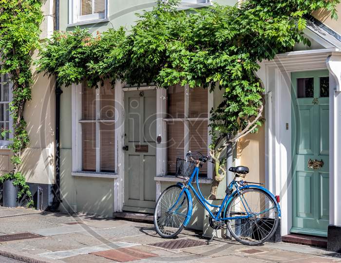 A Blue Bicycle Leaning Against A House In Sandwich Kent