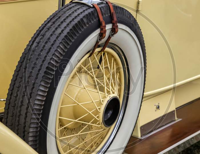 Spare Wheel On A Vintage Yellow Rolls Royce