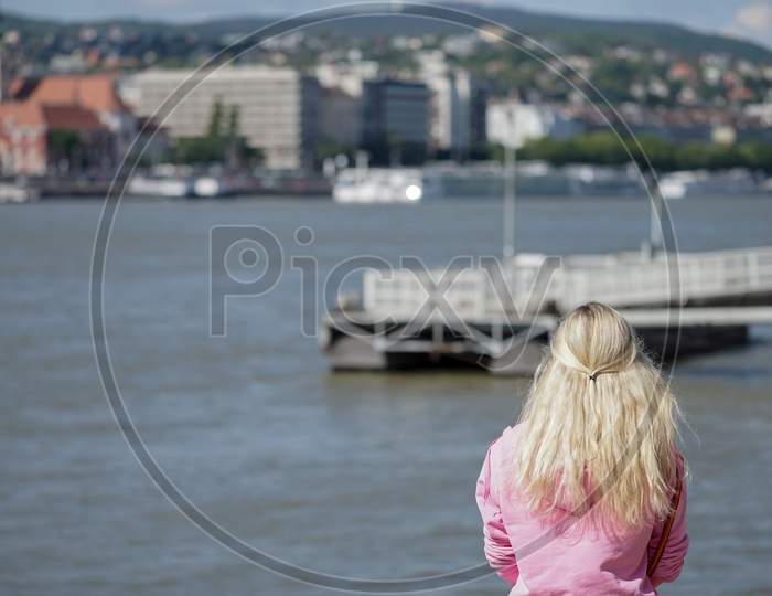 Lady Looking At The River Danube In Budapest