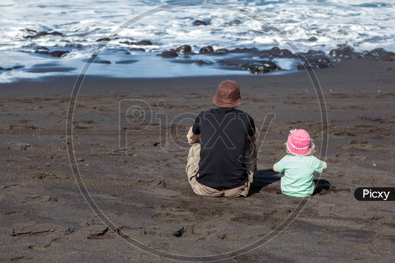 Dad And Daughter Watching The Waves
