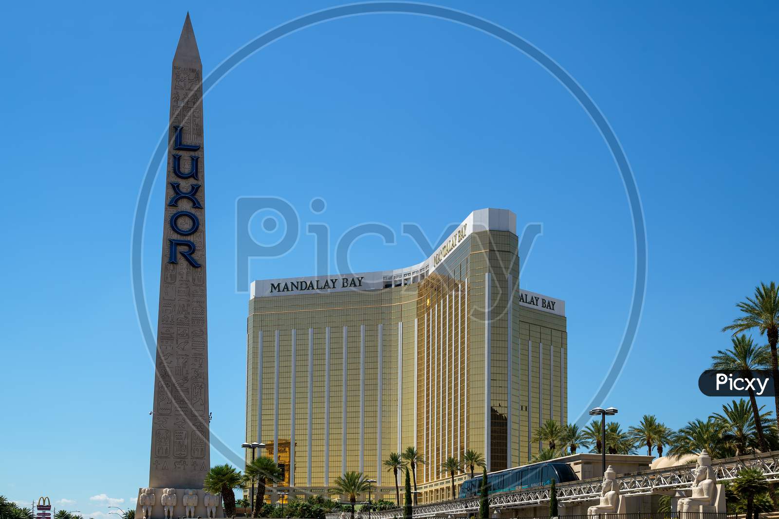 Las Vegas, Nevada, Usa - August 1 : Replica Cleopatra'S Needle At The Luxor Hotel With The Mandalay Bay Hotel In Las Vegas On August 1, 2011