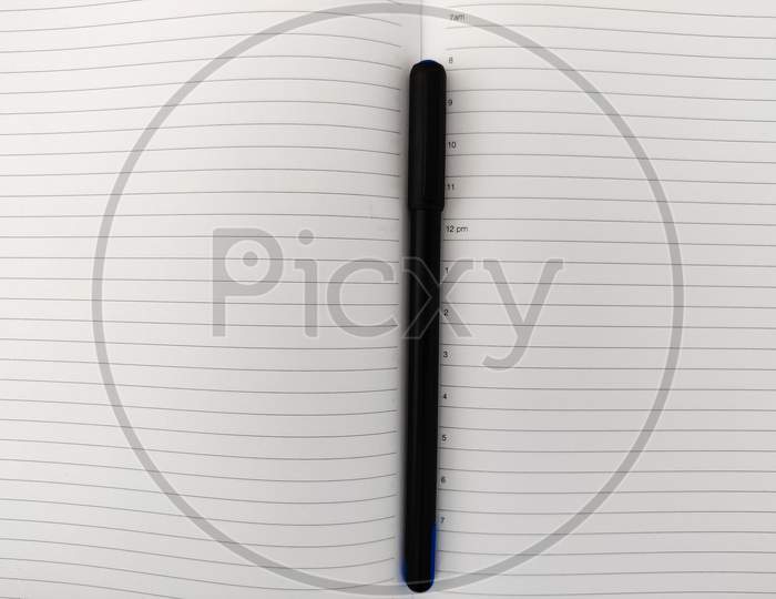 Top View Of Open Diary With Pen. Copy Space