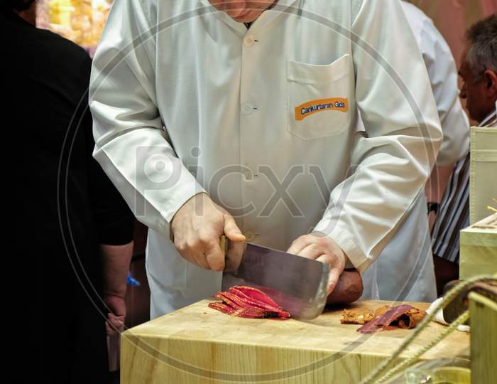 Istanbul, Turkey - May 25 : Man Slicing Meat In The Spice Bazaar In Istanbul Turkey On May 25, 2018. Unidentified People