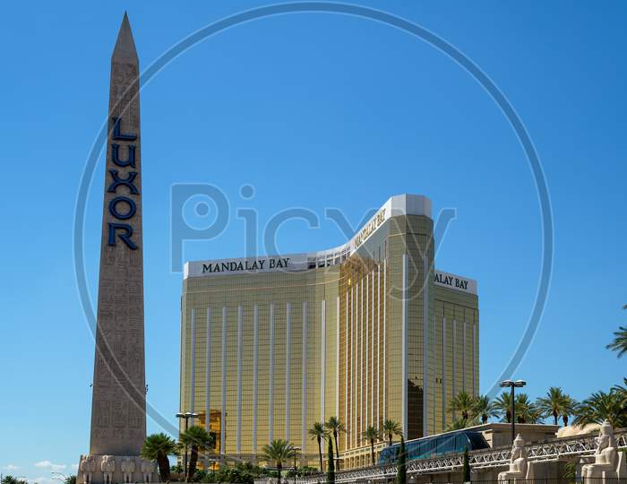 Las Vegas, Nevada, Usa - August 1 : Replica Cleopatra'S Needle At The Luxor Hotel With The Mandalay Bay Hotel In Las Vegas On August 1, 2011