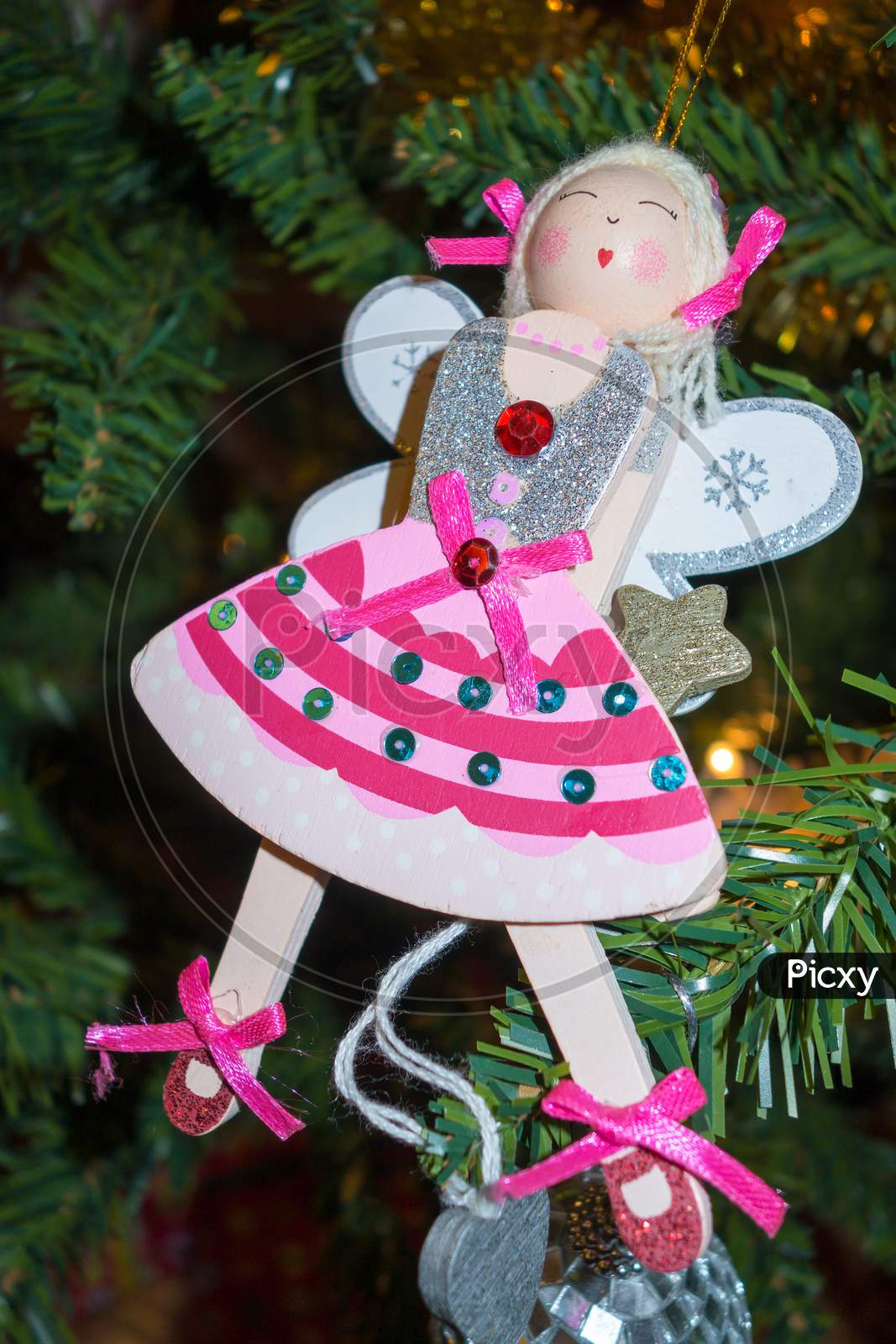 Funky Angel Decoration Hanging On A Christmas Tree