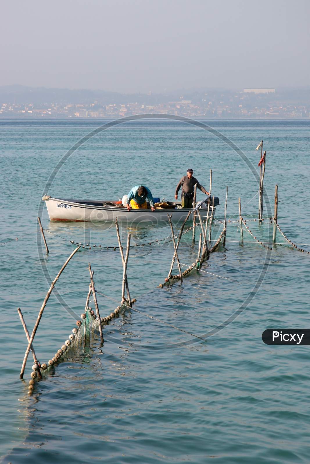 Fishermen Checking Their Nets At Lake Garda