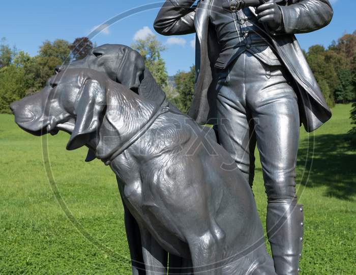 Statue Of A Man And Two Dogs At The Imperial Kaiservilla In Bad Ischl