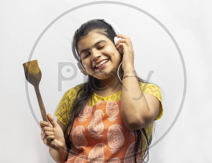 Indian Housewife In Kitchen