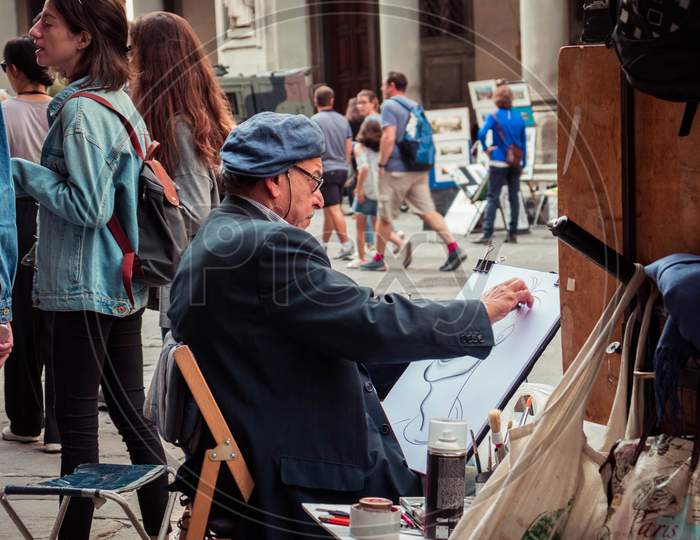 Street artist drawing a portrait
