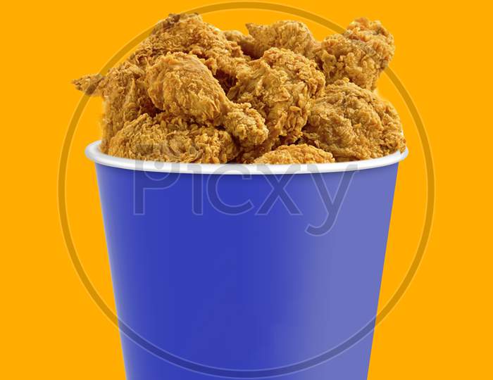 Tasty Deep Fried Chicken Pieces On Orange Background , Closeup. Chicken Bucket. Space For Text.