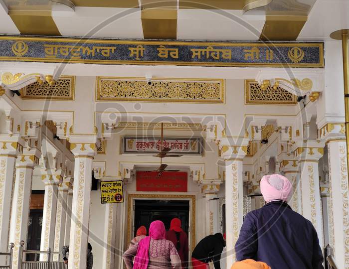 Sikh people entering the gurudwara to offer prayers