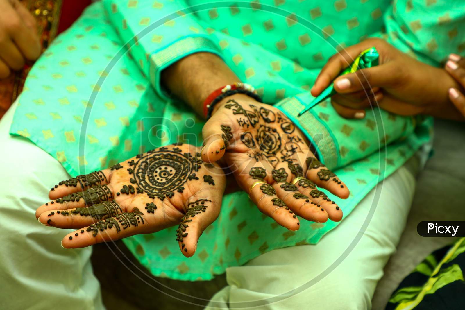 Indian Groom hands decoration with Heena Designs