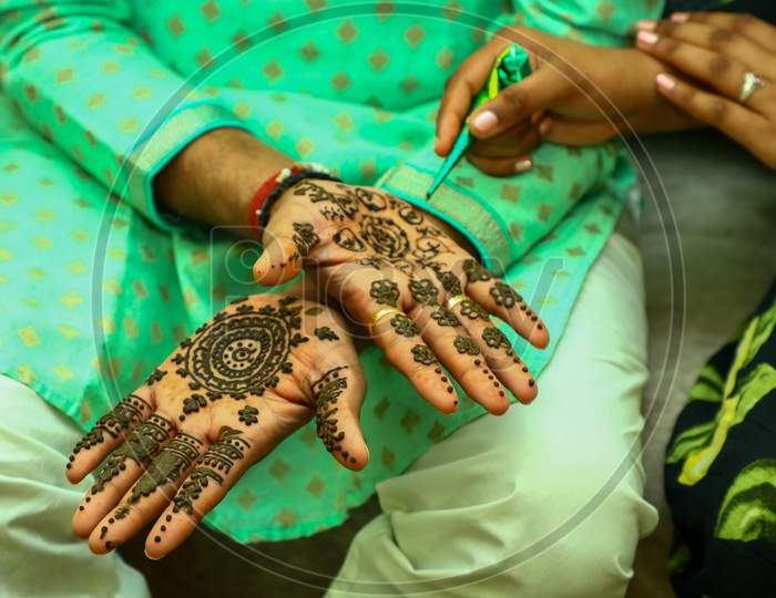 Indian Groom hands decoration with Heena Designs