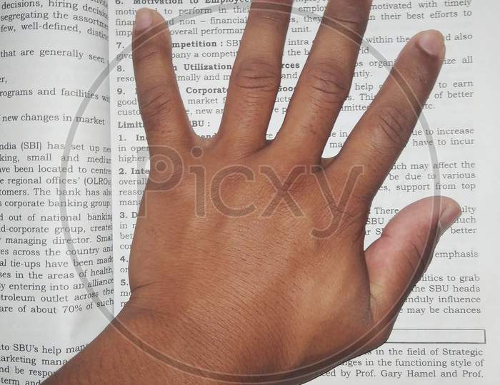 Hand, hand on book,  boys hand close up, fingers