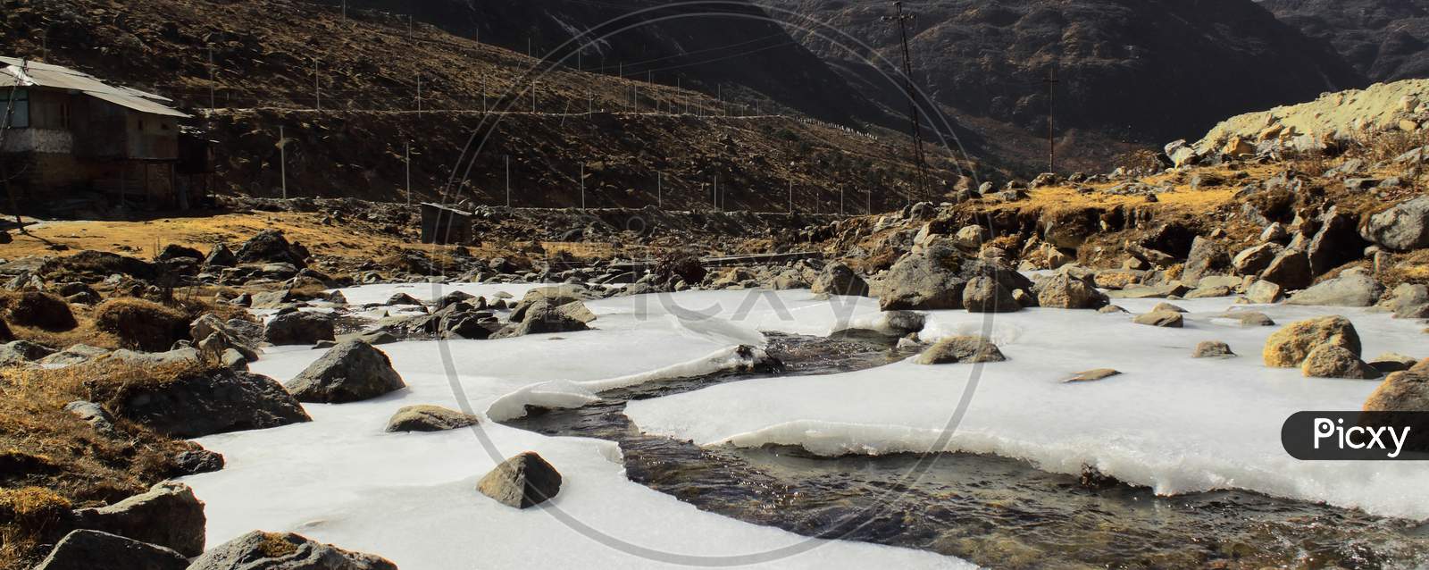 frozen stream (nuranang chu river) and valley in winter season near sela pass in tawang, arunachal pradesh, north east india