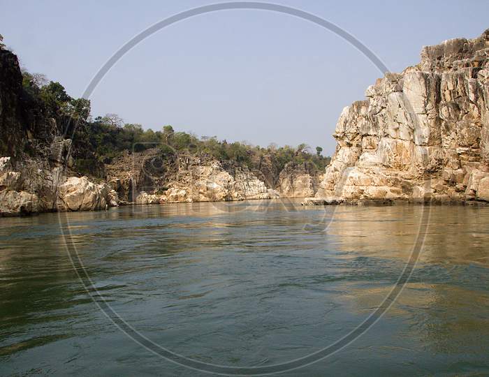 River Flanked By Rocks At Bedaghat