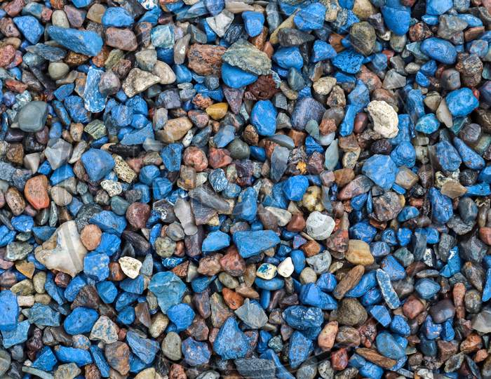 Close Up View On Blue Pebbles And Stones On A Gravel Ground Texture In High Resolution