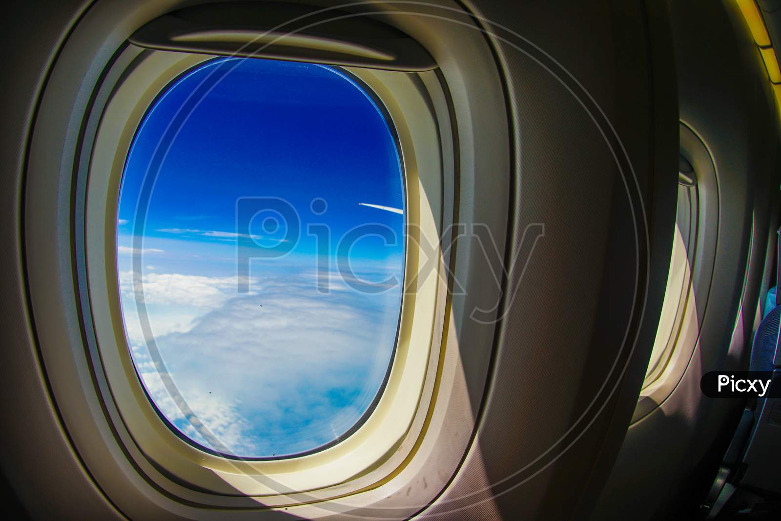 Clouds And Sky Visible From The Window Of An Airplane
