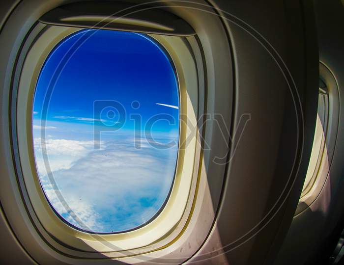 Clouds And Sky Visible From The Window Of An Airplane