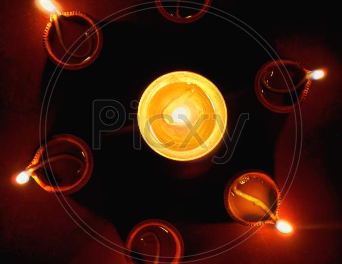 Close up shot of Diya or oil lamp on dark background on the occasion of Diwali festival of lights, India traditional fastival